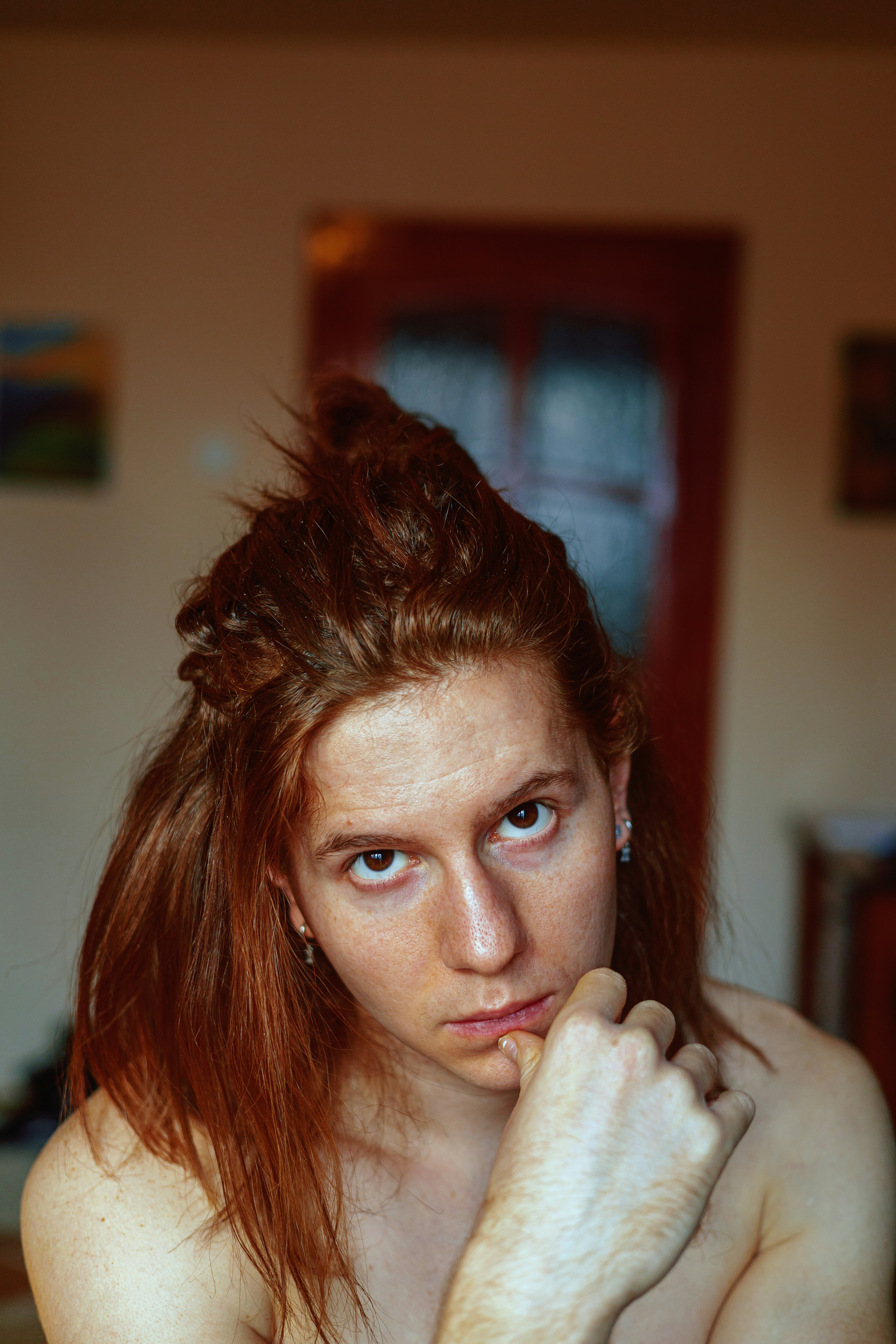 a woman with red hair is posing for a picture
